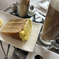 Vegan lemon cake with oat latte  at Coffee Bistro Zu  in Selby