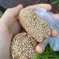 Fried sesame balls. Round one is filled with peanut, long one with shredded sweet caramelized coconut  at Pan Cake and Steam Rice Cake Stall in Penang