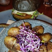 Hamburguesa vegana con pan negro. at Faire Tapas & Wine in Barcelona