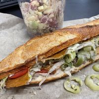 Delicious French bread sub sandwich w German potato salad   at Black Market Meats in Lakewood