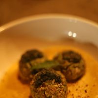Veggie balls in a carrot cream with pesto and pumpkin seed parmasan at Aliado Bar & Aperitivo in San Juan