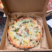 Vegan pizza with pineapple, spinach, garlic and vegan cheese    at Firenza Kitchen in Lindenhurst