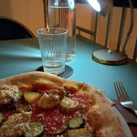 Pizza Semplice (con pomodoro, patate, zucchine, olive, origano, hummus di ceci) at Lestro Pizza Restaurant in Brescia