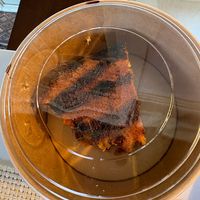 Takeaway “service”: dessert packed upside down, icing ruined, then charged extra.  at Casa Vegetariana in Porto