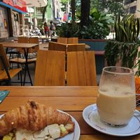 Smoked tofu scramble croissant and oat milk coffee at Teva Deli in Rio De Janeiro