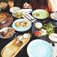 Royal Couple Brunch and Tivonina (black dish and focaccia on the right side) at Meshek Barzilay in Tel Aviv