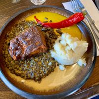 Smoke-grilled pumpkin with lentils and curry sauce at Meshek Barzilay in Tel Aviv