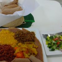 Sampler platter with injera bread and side salad. at Lulu EthioVegan in Minneapolis
