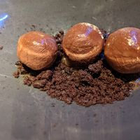 Diving wasabi chocolate truffles on crunchy cookie crumbs at Rasoterra in Barcelona