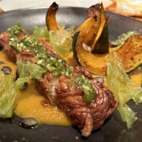 Homemade almond TEMPEH, Hokkaido pumpkin, seeds, gremolata  at Rasoterra in Barcelona