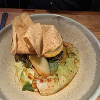 Chickpea and potato curry with a wafer thin pappadum .  at Rasoterra in Barcelona