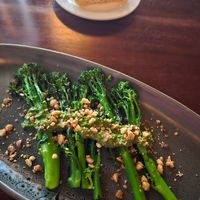 Charred brokkolini with lemon and almond chili flakes at Osprey's Restaurant in Oak Beach