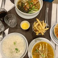 Chicken tikka masala and tofu ramen, and garlic butter chips with cheese sauce   at Veganapati in Lisbon
