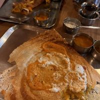 Masala dosa with a bite out of it... Ginger tea on the right.  at Anantha Bhavan Inn in Fort Kochi