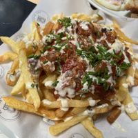 French fries with tomato sauce and onions, eggplant and more  at Blossom Owl in Kalamata