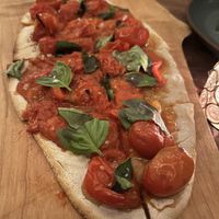 Gluten free version of the cherry tomato flatbread  at Bar Avelo in Toronto
