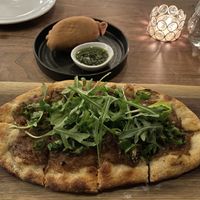 Caramelized onion flatbread and lentil empenada.  at Bar Avelo in Toronto