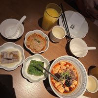 Selection of dishes including a passion fruit drink, mapo tofu and sour vegetables  at Qing Chun By Perma in Shanghai