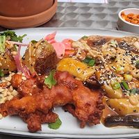 Spicy potatoes + tteokbokki with oyster wings at YUBA  in Poznan