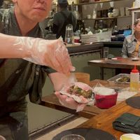 Chef adding the cherry blossom powder to the sakura-broccoli hand roll  at veggie tempo & sushi in Tokyo