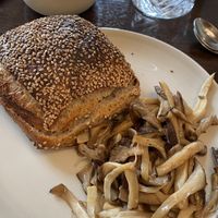 Mushrooms with bread roll and oat latte  at Rug Bakery in Copenhagen