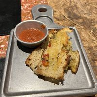 Complimentary focaccia and sauce    at Almacen De Pizzas in Asuncion