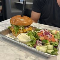 Chicken sandwich with a side of salad at Brick City Vegan in Montclair