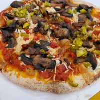 Pizza has mushrooms, onions, jalapeños, sun dried tomatoes at Mexitaly in York