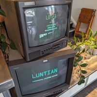 The logo displayed on old school monitors at Luntian in Auckland