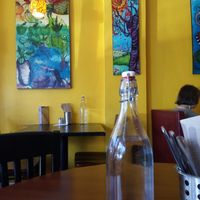Filtered water for the tables, colorful art on the walls at Portia's Cafe in Columbus