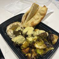 Built our own bowl with hummus, falafel, pita, and Brussel sprouts    at SLC - Vessel Kitchen - Concourse A in Salt Lake City