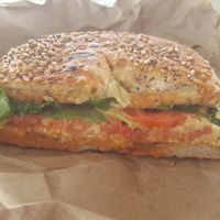 Toasted everything bagel with homemade hummus, tomato, spinach, hot sauce at The Green Bean in New Bedford