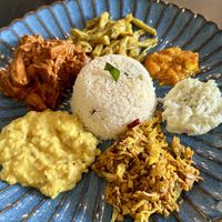 Signature curry leaf coconut rice with dry curries and chambals   at Kunthaville in Central Singapore