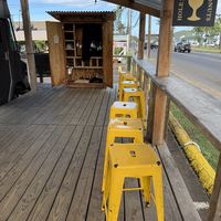 Seating area and merch too  at Holey Grail Donuts  in Kapaa