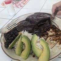 Mole enchiladas with beans rice and avocado at Comedor Angeles in Oaxaca