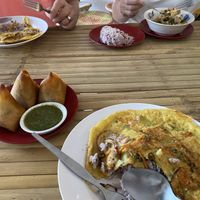 Chickpea omelet, samosas with coriander chutney, kimchi bowl  at Free Bird Cafe Pai in Pai