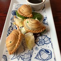 Thai Chives Puff appetizer. Seasoned chopped chives vegetables wrapped in puff pastry and deep fried. Served with Thai-chili soy dipping sauce. at Joy's Pattaya Thai Restaurant in Richfield