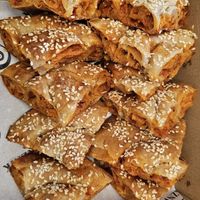 Ajvar and potato maznik cut into quarters for catering. at Maznik in Spotswood