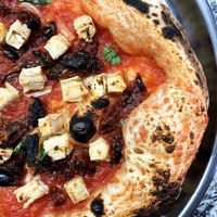 Luxury vegan pizza with tomato sauce, basil, garlic, sun-dried tomatoes, cashew-camembert and olive oil at Daner Pizza in Tbilisi