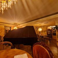 Beautifully decorated restaurant with piano, wall paitings and antique furniture at Marie Miner Gastrospace in Santiago De Compostela