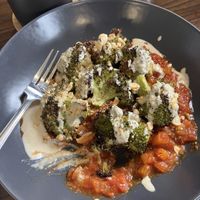 Roasted broccoli, tomato ragu, tahini cream and hazelnuts  at The Station Coffee + Kitchen in Stokesley