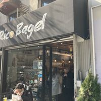 Front entrance; there are some tables to eat outside, no tables or seating inside. at Rico Bagel in New York City