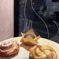 A vegan cinnamon bun, vegan clementine and cardamom bun and a vegan chocolate covered cupcake at Greyhound Coffee  in Poulton-le-fylde
