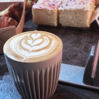 Oat milk latte and vegan school cake at Greyhound Coffee  in Poulton-le-fylde