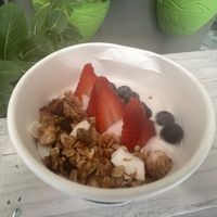 Coconut yogourt with fruit and homemade granola  at Clover Coffee + MarketPlace in Oranjestad