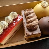 L - R: Strawberry and Lemon Opera, Coffee and Chocolate Opera, Passionfruit Rocher, Biscoff and Chocolate Rocher at GingerSnap Patisserie in West Melbourne