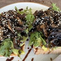 Mushrooms and arugula avocado toast.   at Bugaloe in Noord