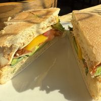 The “Erin” Sandwich - veggie mayo, chickpea salad, salt, bell pepper, cucumber, tomato, red onion, smoked tofu, spinach and hot sauce   at Soulstice Tea Room & Noshery in 100 Mile House