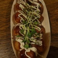 Takoyaki served on a paper boat at Vegan and Gluten Free Osaka. - The Second Room Cafe in Osaka
