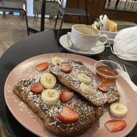 Vegan French toast with fresh fruit, cappuccino with soy milk .  at Cafe Unido in Panama City